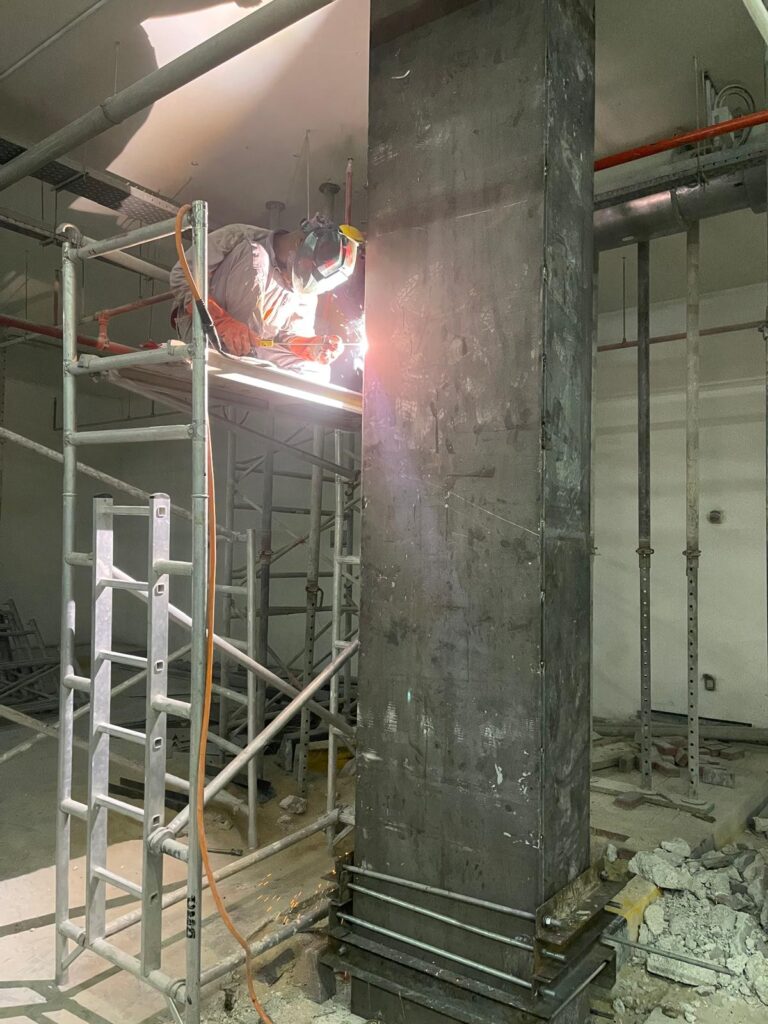 Full encasement of the concrete column with steel plates.