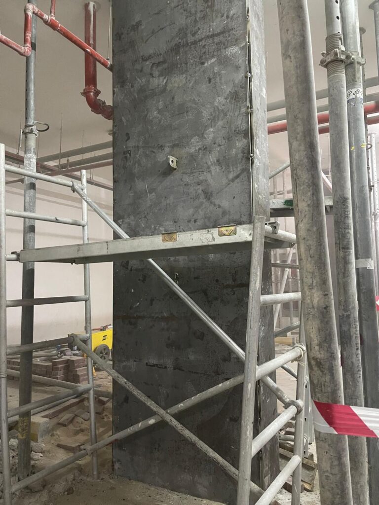 Full encasement of the concrete column with steel plates.
