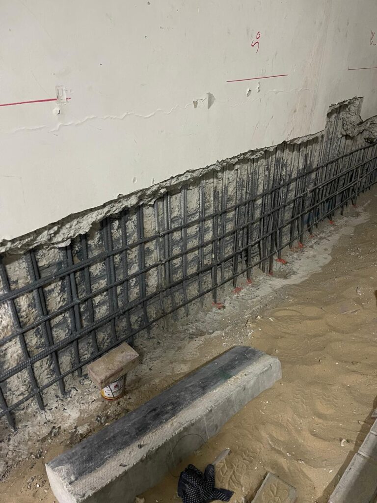 Repairing parts of retaining wall with additional steel installed and welding to the original steel that was still in good condition according to QCS.